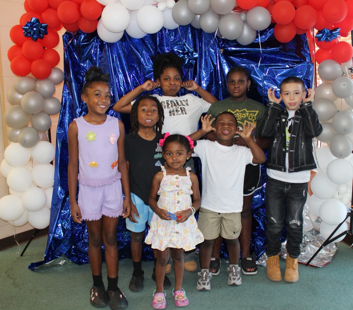 Young people at Young Steppers event with festive balloon backdrop